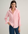 Model is wearing UNTUCKit Isabella shirt in pink and white stripe. 