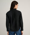 Model is wearing UNTUCKit Isabella shirt in black. 