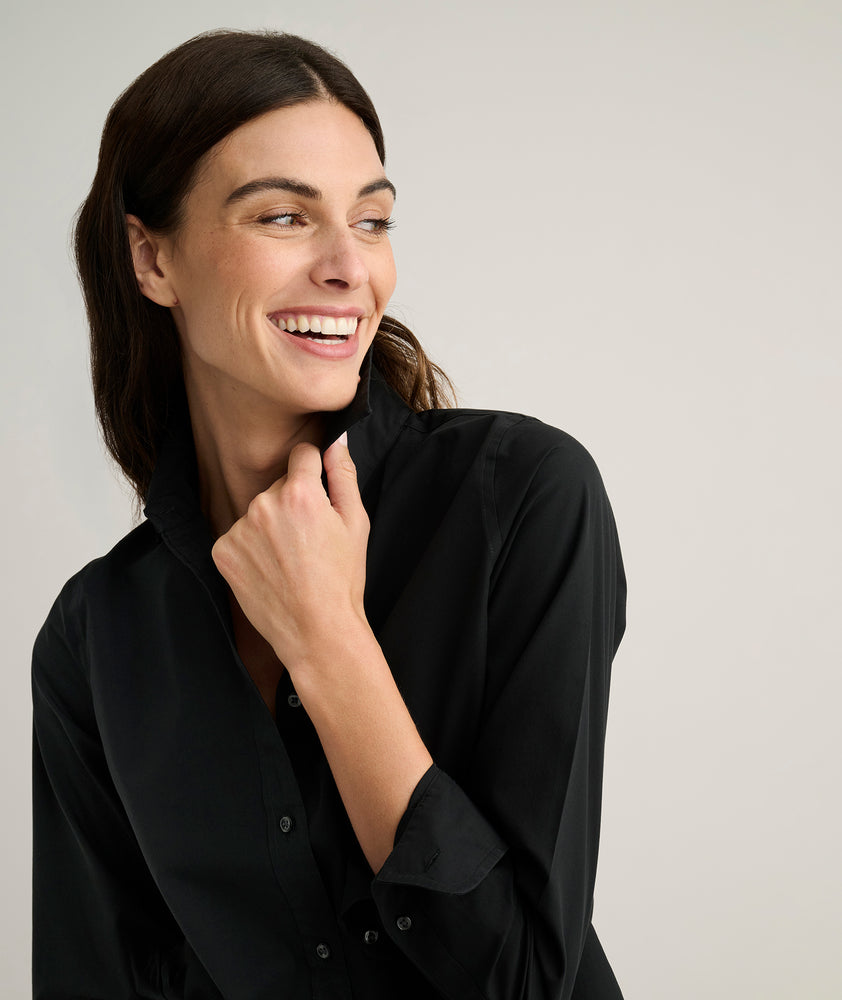Model is wearing UNTUCKit Isabella shirt in black. 