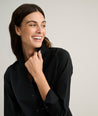 Model is wearing UNTUCKit Isabella shirt in black. 