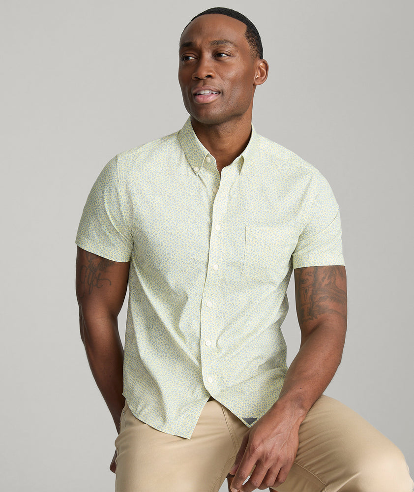 Model is wearing UNTUCKit Ivers performance shirt in yellow. 