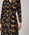Model is wearing UNTUCKit Janice dress in black.