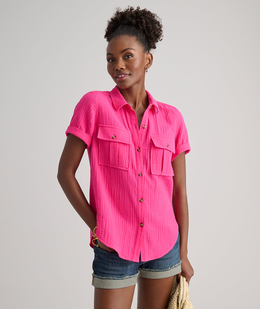 Model is wearing UNTUCKit Jodi shirt in solid pink. 