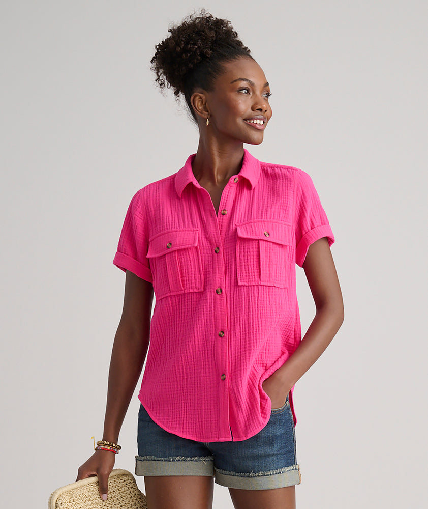 Model is wearing UNTUCKit Jodi shirt in solid pink. 
