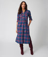 Model is wearing UNTUCKit Joni plaid navy dress.