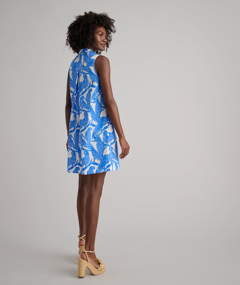 Model is wearing UNTUCKit Jordan printed birds dress in blue. 