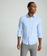 Model is wearing UNTUCKit Kaleb long sleeve performance shirt in light blue and white check. 