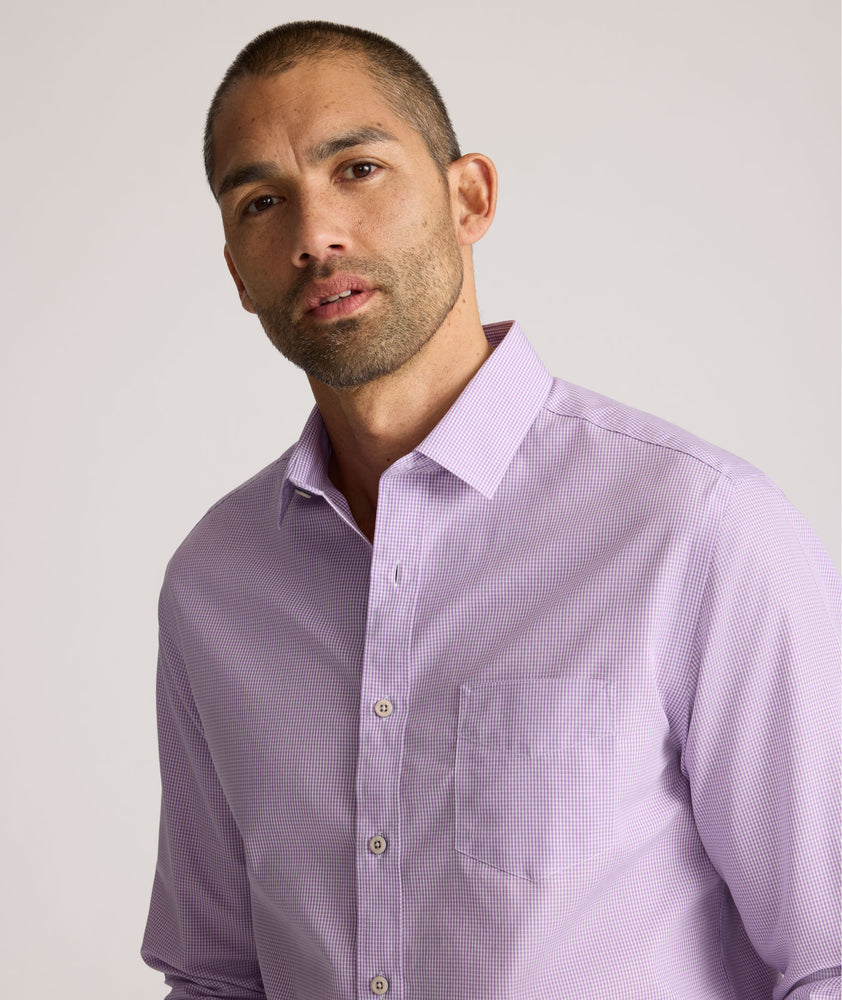 Model is wearing UNTUCKit Kelly wrinkle free shirt in purple gingham.