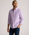Model is wearing UNTUCKit Kelly wrinkle free shirt in purple gingham.