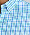 Model is wearing UNTUCKit Kenmare wrinkle-free shirt in teal check. 