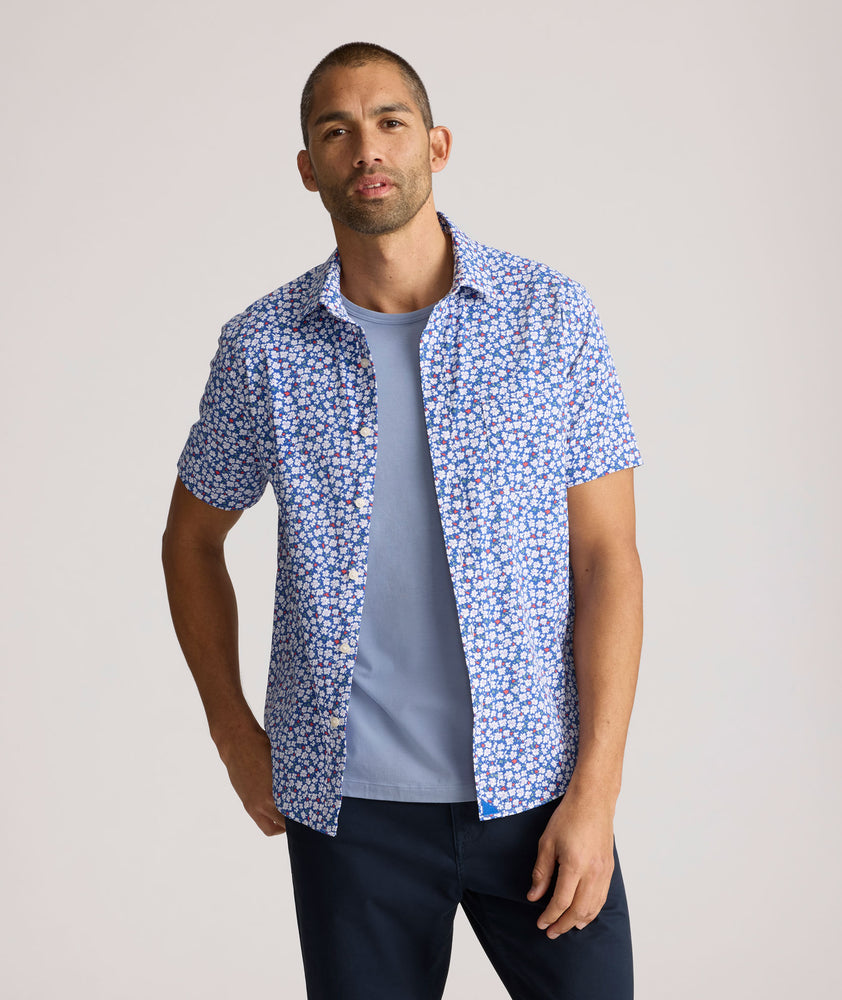 Model is wearing UNTUCKit Kincaid shirt in blue floral print. 
