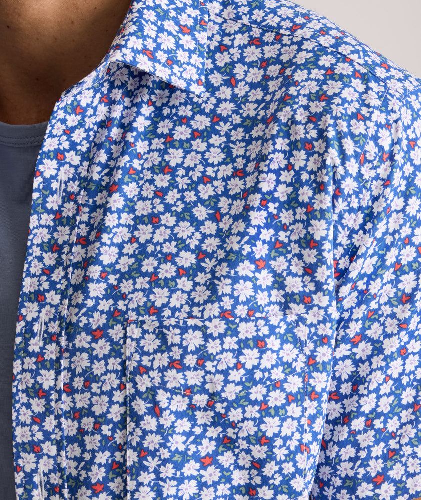 Model is wearing UNTUCKit Kincaid shirt in blue floral print. 