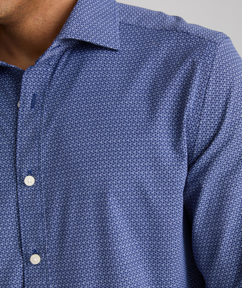 Model is wearing UNTUCKit King shirt in blue with small geo print. 