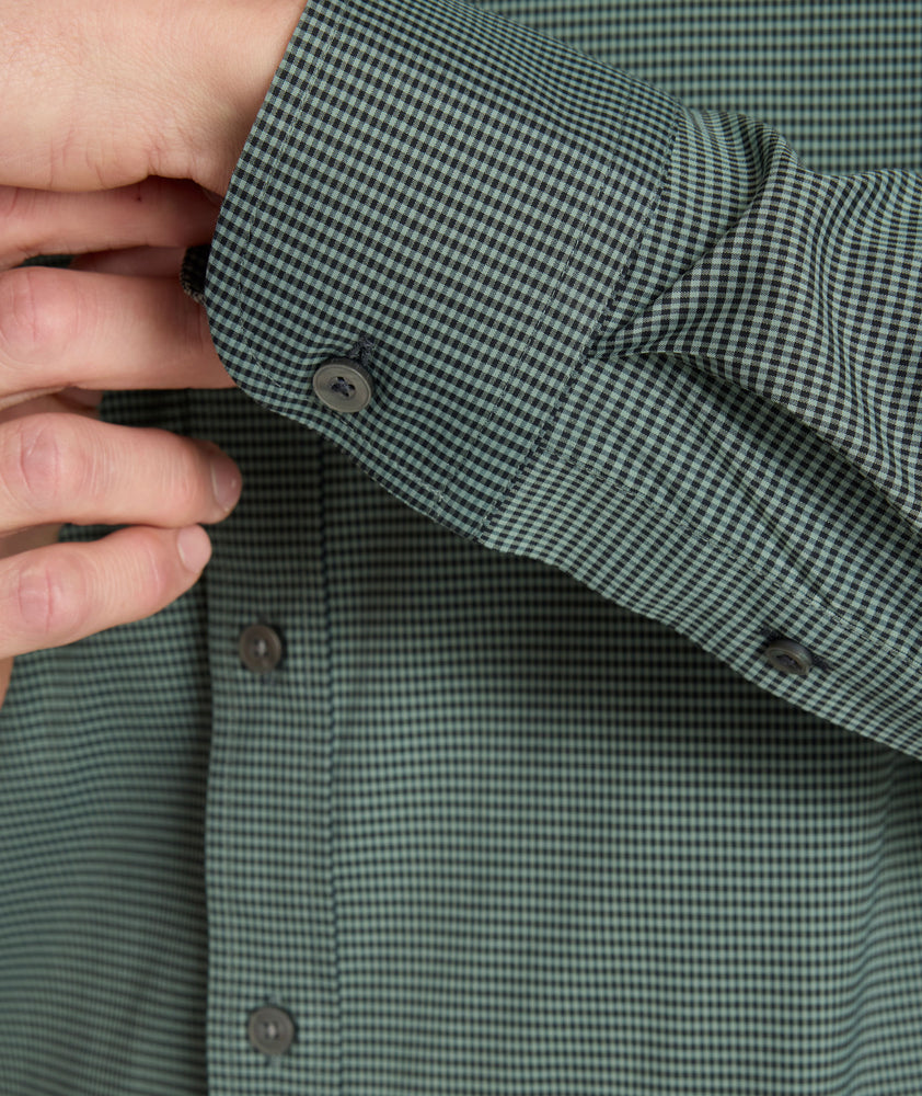 Model is wearing UNTUCKit CottonTek Kleinwood Shirt in green and black plaid. 