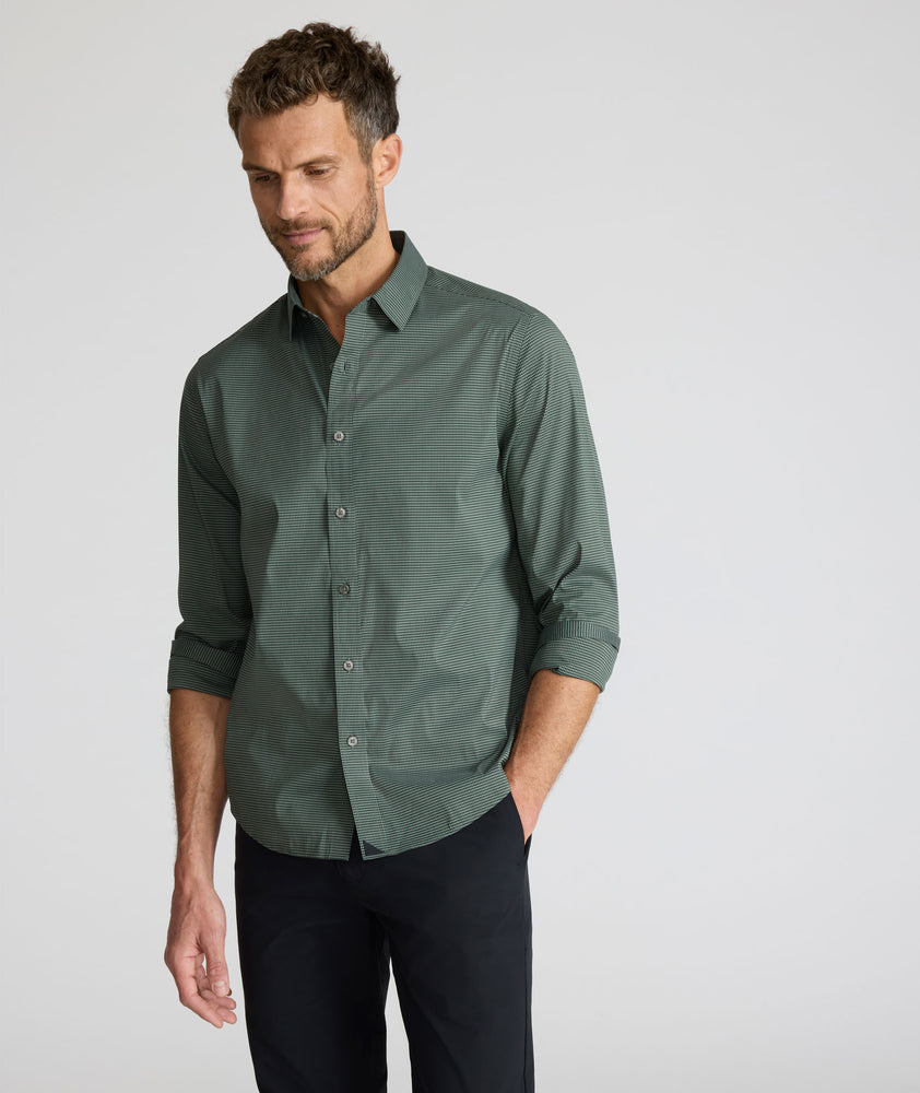 Model is wearing UNTUCKit CottonTek Kleinwood Shirt in green and black plaid. 