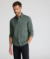 Model is wearing UNTUCKit CottonTek Kleinwood Shirt in green and black plaid. 
