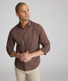 Model is wearing UNTUCKit CottonTek Brachetto Shirt in brown gingham. 