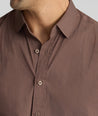 Model is wearing UNTUCKit CottonTek Brachetto Shirt in brown gingham. 