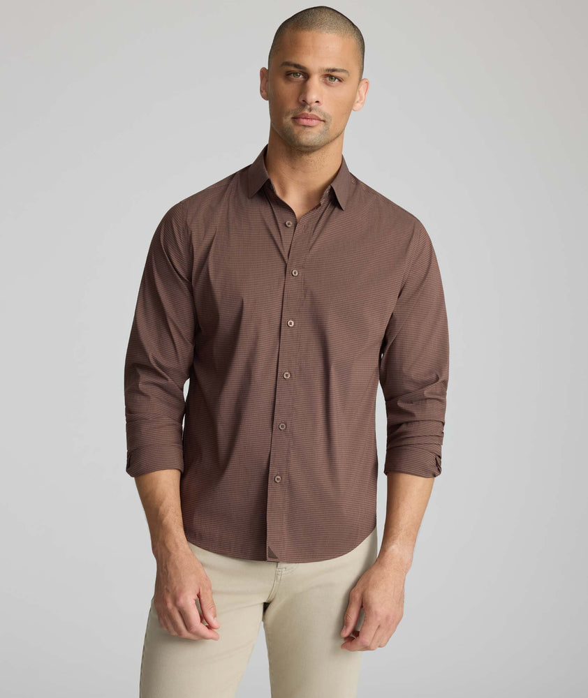 Model is wearing UNTUCKit CottonTek Brachetto Shirt in brown gingham. 