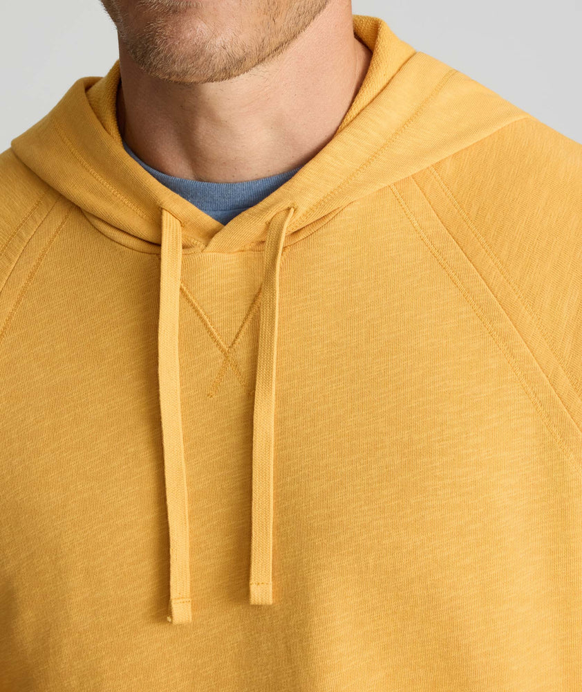 Model wearing an UNTUCKit Hoodie in yellow.