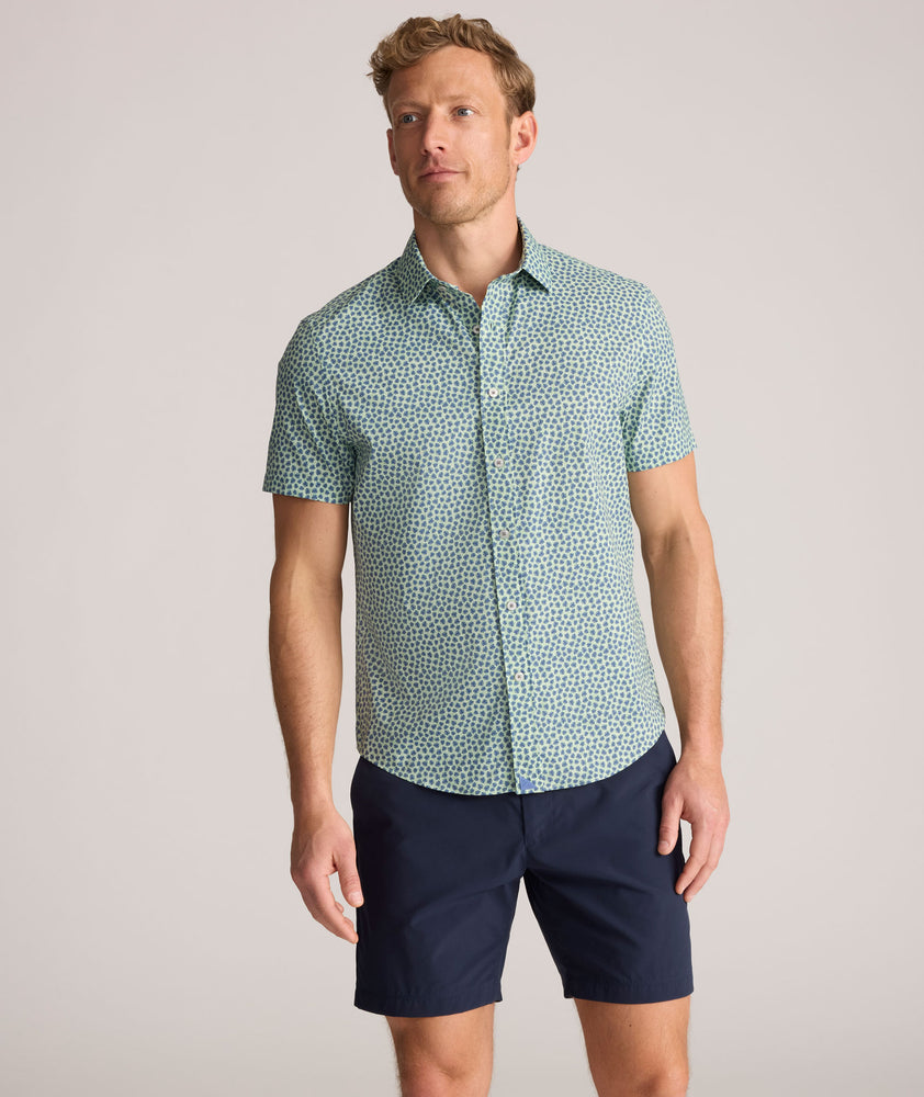 Model is wearing UNTUCKit Performance Short-Sleeve Kyros Shirt in Green Palm Print.