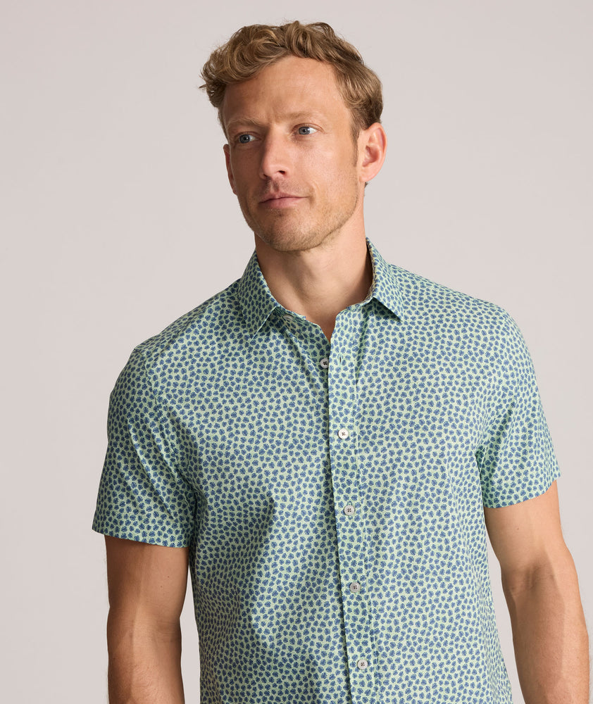 Model is wearing UNTUCKit Performance Short-Sleeve Kyros Shirt in Green Palm Print.