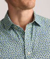 Model is wearing UNTUCKit Performance Short-Sleeve Kyros Shirt in Green Palm Print.