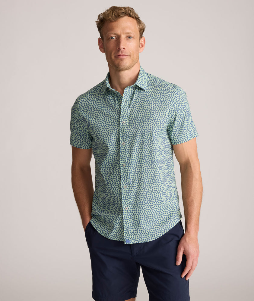 Model is wearing UNTUCKit Performance Short-Sleeve Kyros Shirt in Green Palm Print.