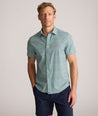Model is wearing UNTUCKit Performance Short-Sleeve Kyros Shirt in Green Palm Print.