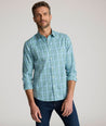 Model is wearing UNTUCKit Lancaster cottontek green shirt. 
