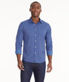 Model is wearing UNTUCKit Wrinkle-Free Performance Langhorne Shirt in Blue Grounded Check.
