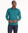 Model is wearing UNTUCKit Wrinkle-Free Performance Langhorne Shirt in Green Grounded Check.
