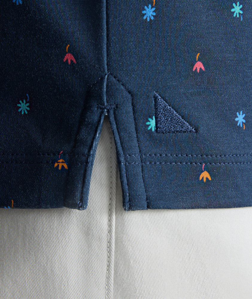 Model is wearing UNTUCKit Wrinkle-Free Damaschino Polo in navy floral. 