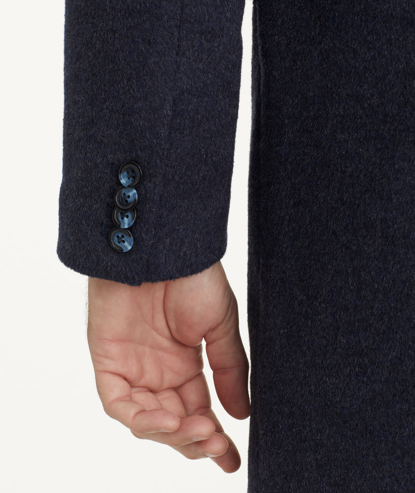 Model is wearing UNTUCKit Wool Blend Topcoat.