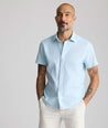 Model is wearing UNTUCKit Performance Short-Sleeve Lobo Shirt in light blue. 