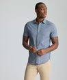 Model is wearing UNTUCKit Performance Short-Sleeve Lobo Shirt in navy.