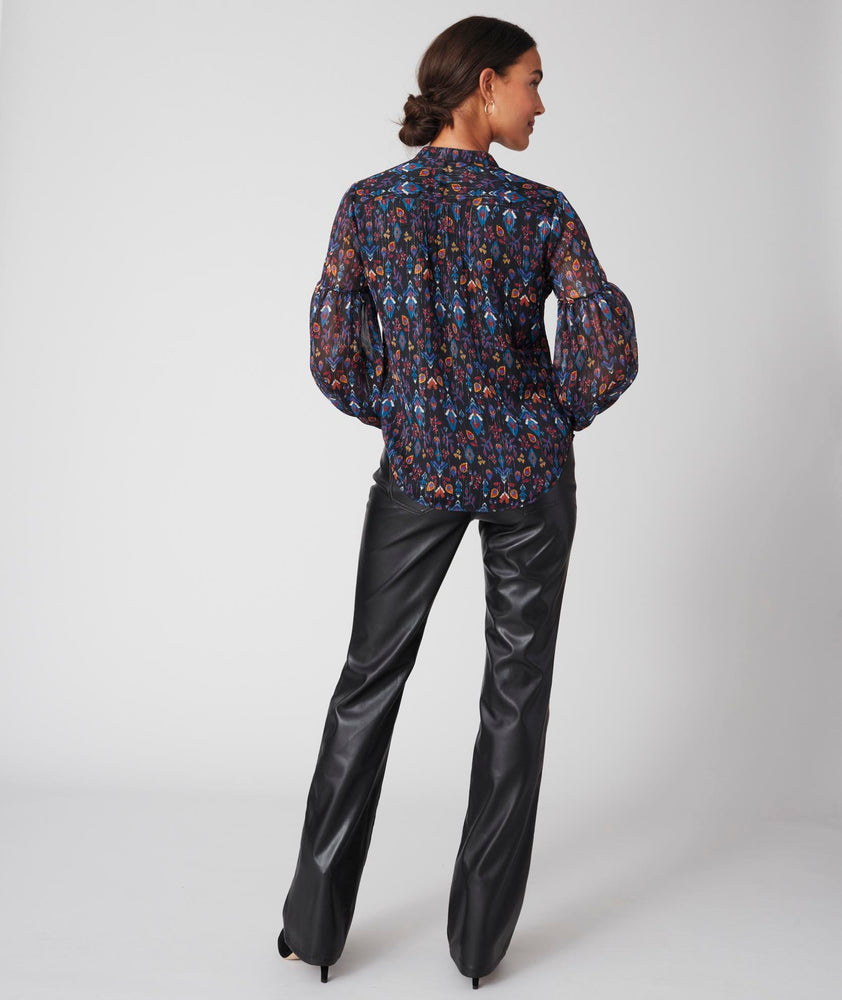 Model is wearing UNTUCKit printed black Lorelei shirt.