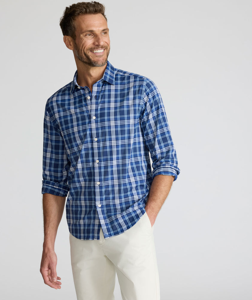 Model is wearing UNTUCKit Performance Mabry Shirt in blue. 