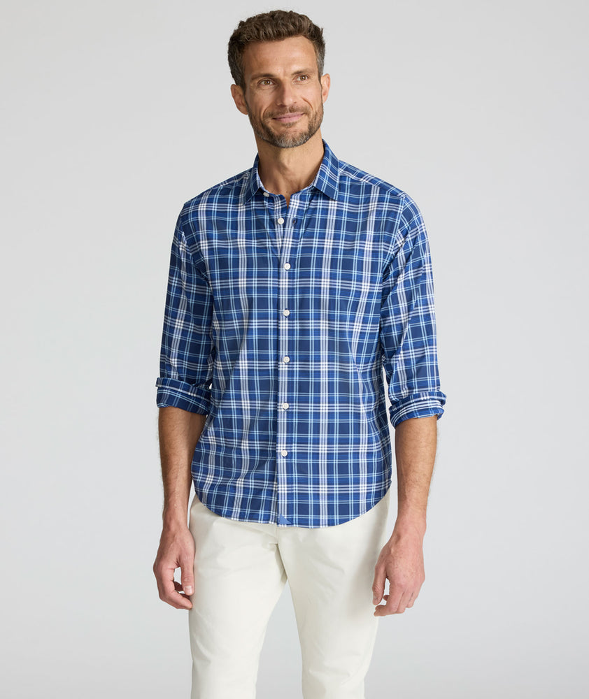 Model is wearing UNTUCKit Performance Mabry Shirt in blue. 