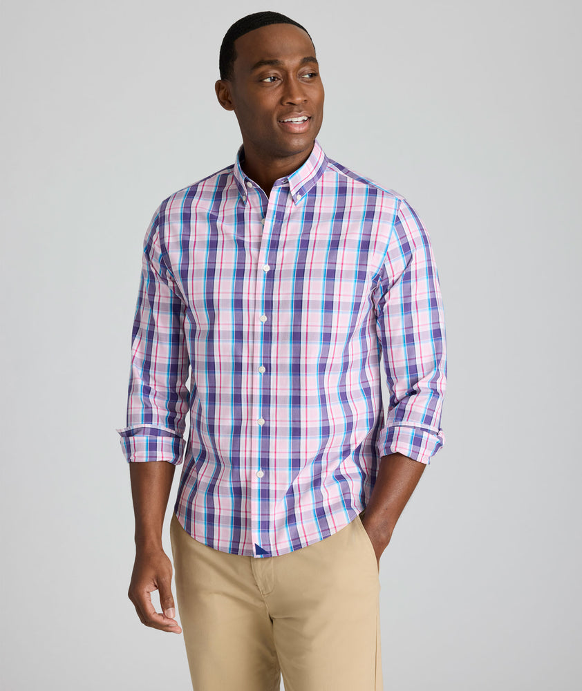 Model is wearing UNTUCKit Maitland wrinkle-free shirt in pink plaid. 