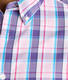 Model is wearing UNTUCKit Maitland wrinkle-free shirt in pink plaid. 