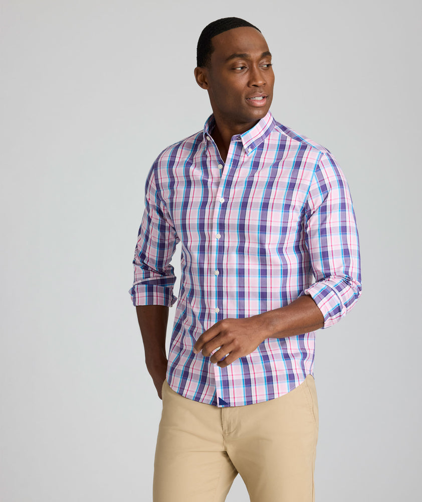 Model is wearing UNTUCKit Maitland wrinkle-free shirt in pink plaid. 