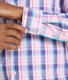 Model is wearing UNTUCKit Maitland wrinkle-free shirt in pink plaid. 