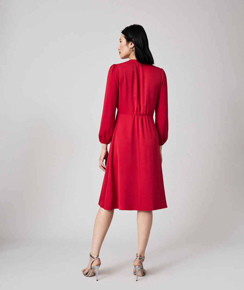 Model is wearing UNTUCKit Malory dress in red.