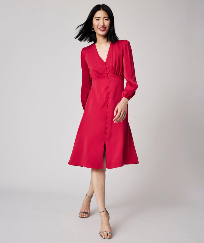 Model is wearing UNTUCKit Malory dress in red.