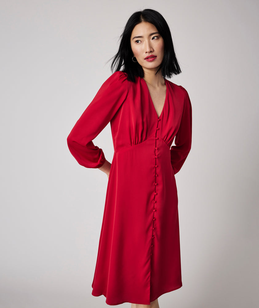 Model is wearing UNTUCKit Malory dress in red.