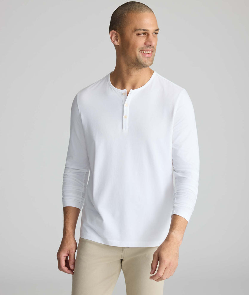 Model wearing a white long-sleeve henley.