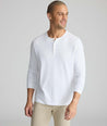 Model wearing a white long-sleeve henley.