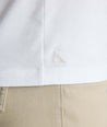 Model wearing a white long-sleeve henley.