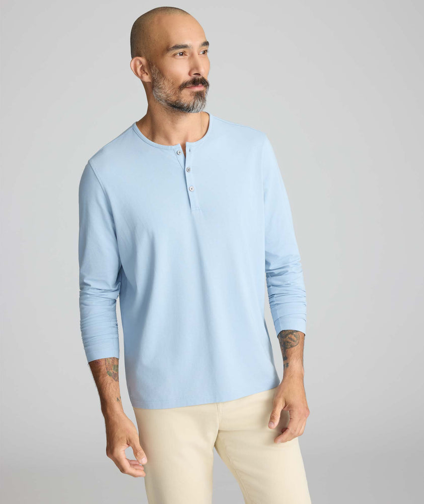 Model wearing a light blue long-sleeve henley.